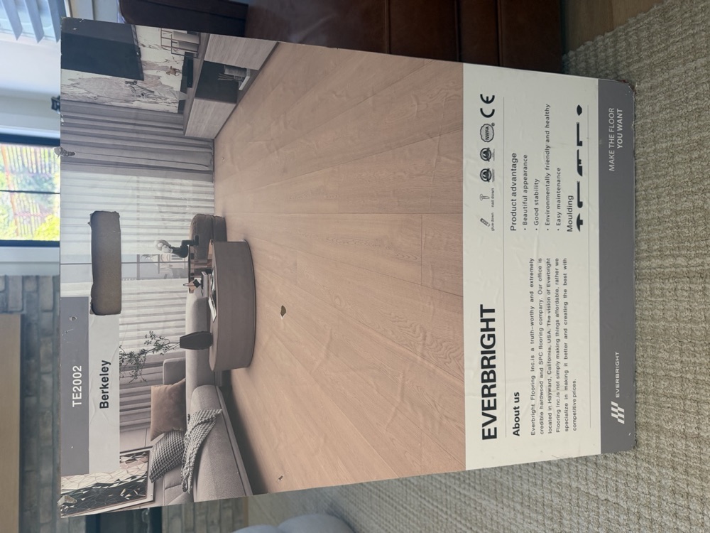 A box of Everbright Berkeley flooring standing in the living room